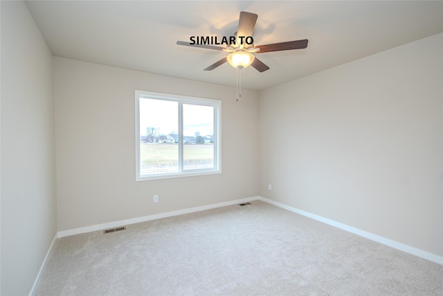 carpeted spare room with a ceiling fan, visible vents, and baseboards