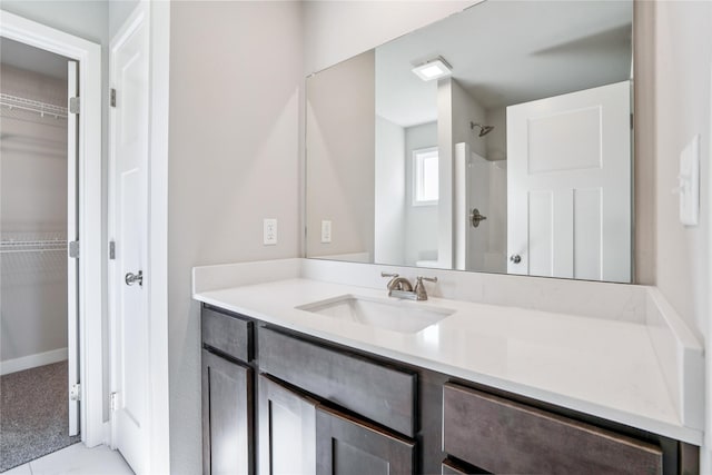 25091 Bluebird Cir, Adel, IA 50003 - bathroom featuring vanity, a walk in closet, and a shower