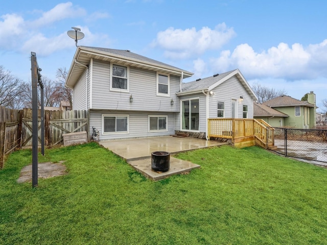 rear view of property featuring a gate, a patio area, a yard, and a fenced backyard