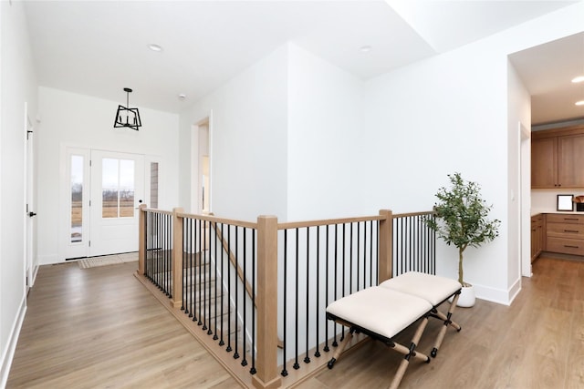 corridor with recessed lighting, light wood-type flooring, and baseboards