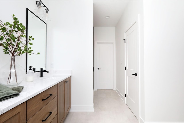 bathroom with vanity and baseboards