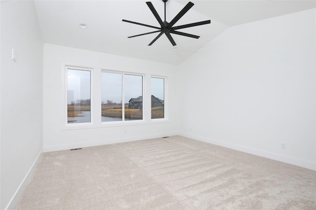 empty room featuring carpet, lofted ceiling, visible vents, ceiling fan, and baseboards