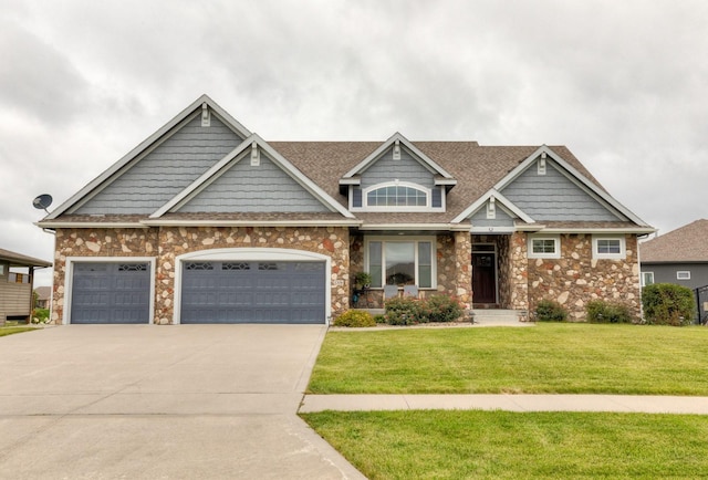 craftsman-style house with driveway, a garage, a front lawn, and roof with shingles