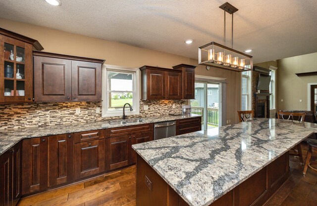 1306 NE 45th St, Ankeny, IA 50021 - kitchen with a sink, stainless steel dishwasher, dark wood finished floors, tasteful backsplash, and recessed lighting