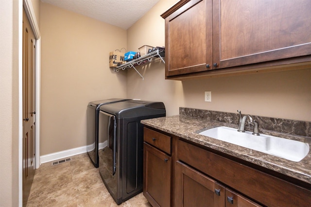1306 NE 45th St, Ankeny, IA 50021 - laundry area with washer and clothes dryer, cabinet space, baseboards, and a textured ceiling