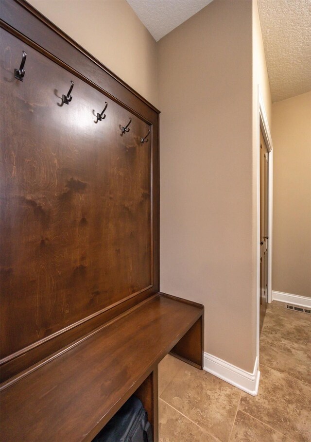1306 NE 45th St, Ankeny, IA 50021 - mudroom with a textured ceiling, baseboards, and light tile patterned floors