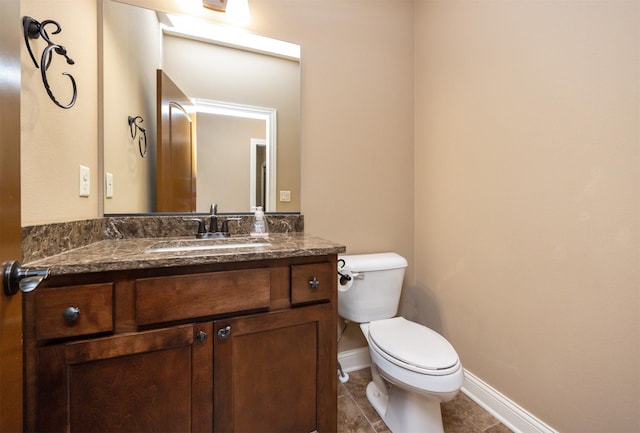 1306 NE 45th St, Ankeny, IA 50021 - half bathroom featuring toilet, vanity, tile patterned flooring, and baseboards
