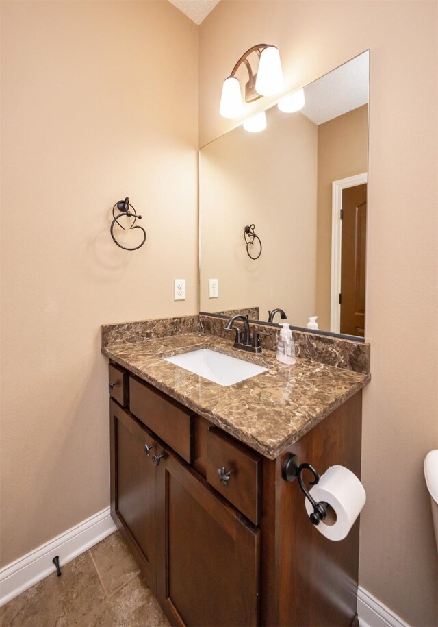 1306 NE 45th St, Ankeny, IA 50021 - half bath with baseboards, vanity, and toilet