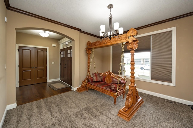 1306 NE 45th St, Ankeny, IA 50021 - foyer featuring arched walkways, a chandelier, ornamental molding, carpet, and baseboards