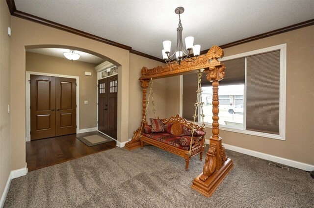 1306 NE 45th St, Ankeny, IA 50021 - foyer featuring arched walkways, a chandelier, ornamental molding, carpet, and baseboards