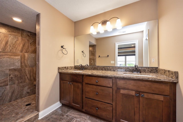 1306 NE 45th St, Ankeny, IA 50021 - full bathroom featuring baseboards, double vanity, a tile shower, and tile patterned flooring