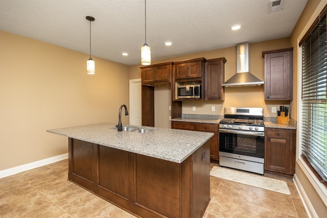 1306 NE 45th St, Ankeny, IA 50021 - kitchen featuring stainless steel appliances, wall chimney exhaust hood, a sink, baseboards, and a kitchen island with sink