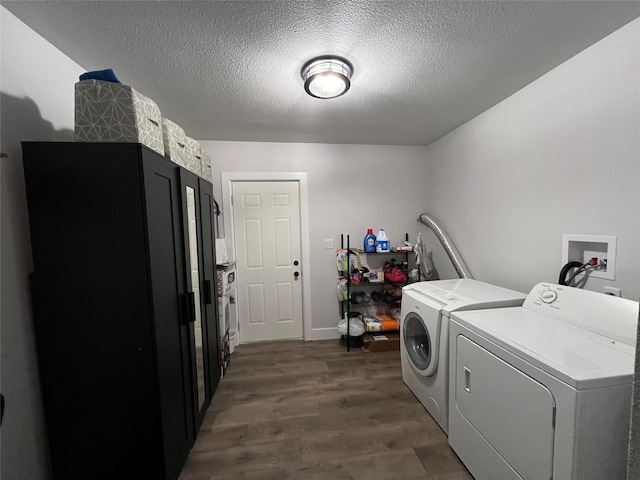 laundry area with dark wood-type flooring, laundry area, washer and clothes dryer, and a textured ceiling