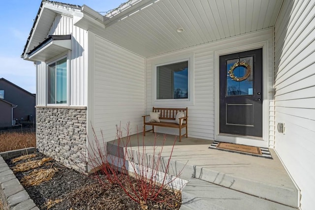 view of exterior entry featuring covered porch