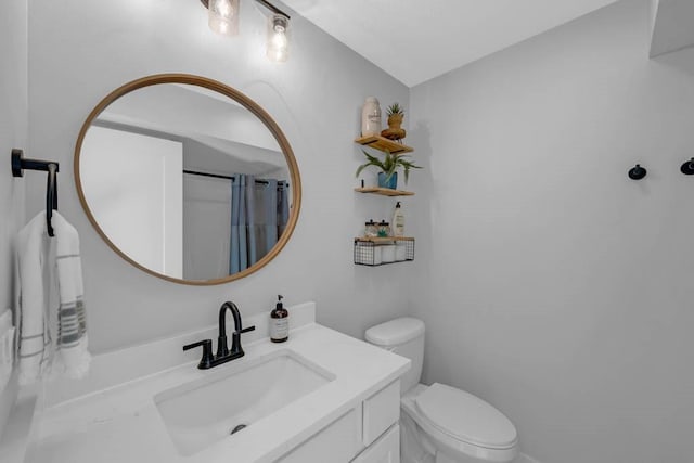 bathroom featuring toilet, a shower with shower curtain, and vanity