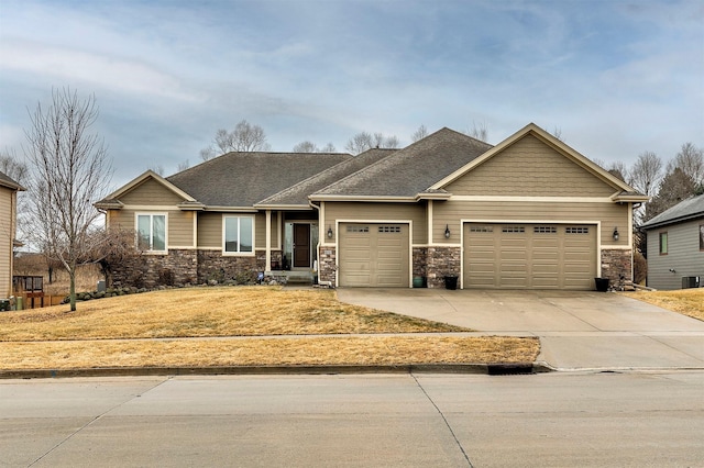 craftsman-style house featuring a garage, stone siding, driveway, and a shingled roof