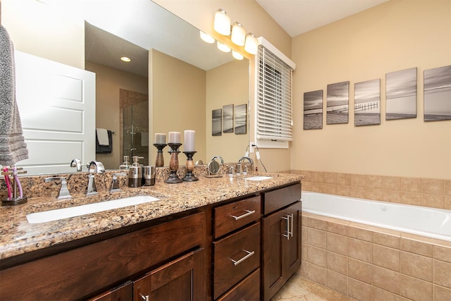 bathroom with double vanity, a sink, a shower stall, and a bath