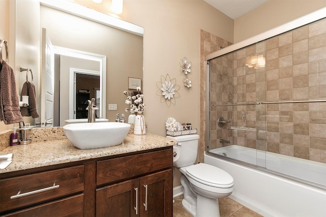 full bathroom with toilet, shower / bath combination with glass door, tile patterned floors, and vanity