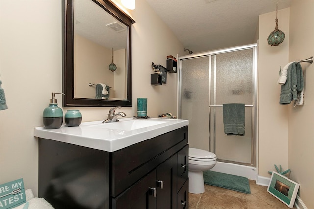 bathroom with visible vents, toilet, a stall shower, vanity, and baseboards