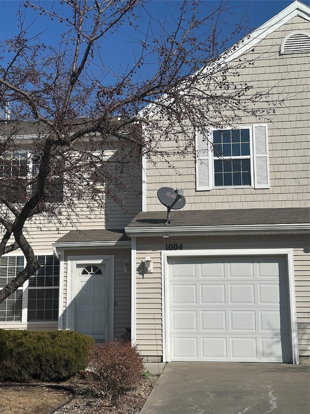 traditional-style home with a garage and driveway