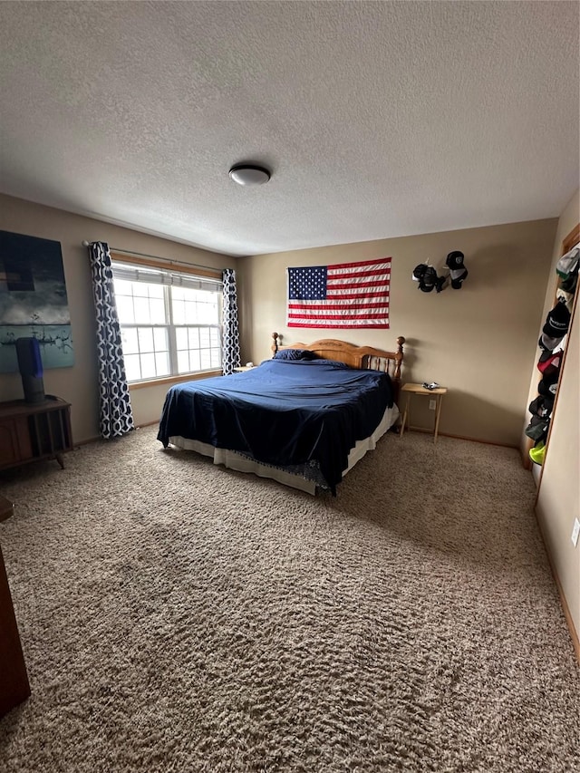 bedroom with a textured ceiling and carpet flooring