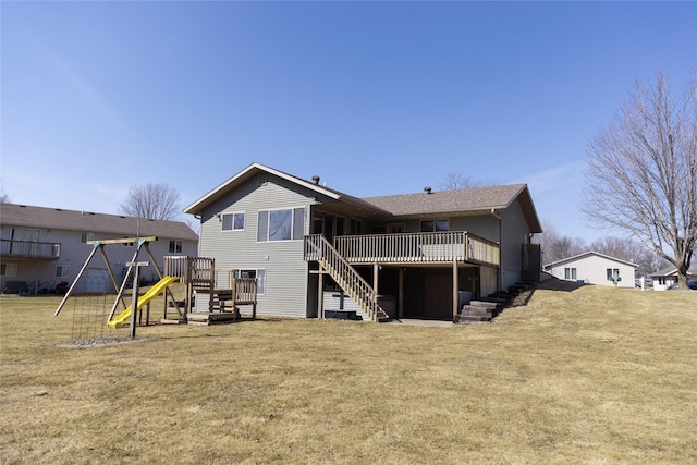 back of property with a playground, a lawn, a deck, and stairs