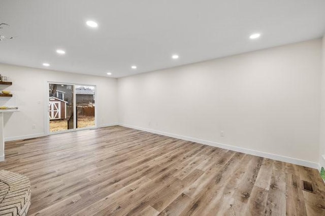 unfurnished living room featuring recessed lighting, baseboards, and wood finished floors