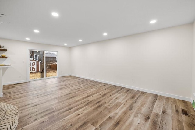basement featuring baseboards, wood finished floors, visible vents, and recessed lighting