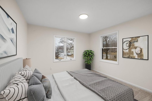bedroom featuring baseboards and carpet flooring