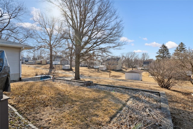 view of yard featuring an outdoor structure and a storage unit