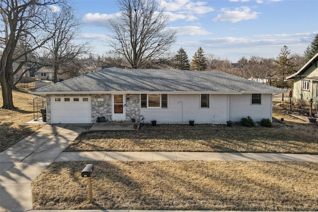 ranch-style house with a garage, driveway, roof with shingles, and stone siding