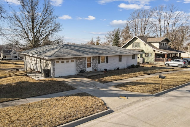 view of front of home with driveway, stone siding, and an attached garage