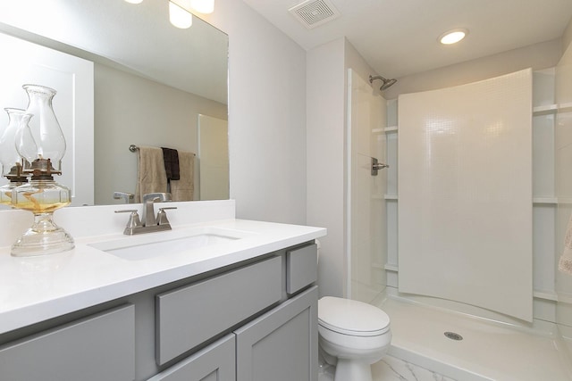 full bath with visible vents, a shower, toilet, marble finish floor, and vanity