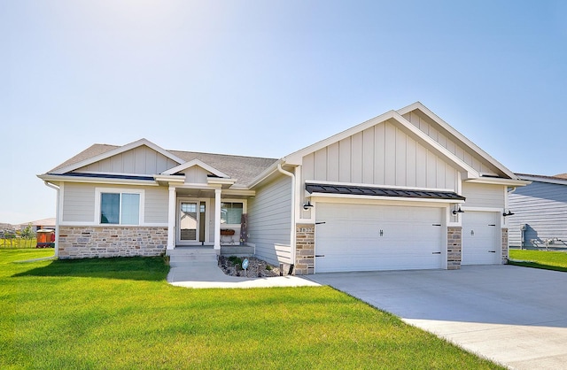 view of front of home with concrete driveway, a standing seam roof, a garage, stone siding, and a front lawn