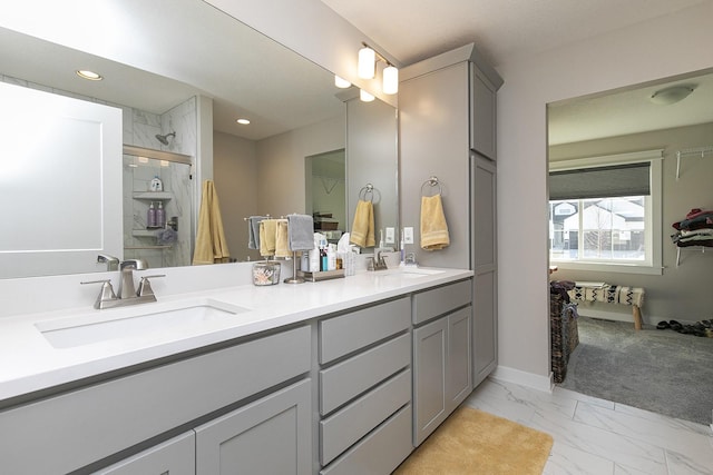 full bathroom featuring recessed lighting, marble finish floor, a sink, and double vanity