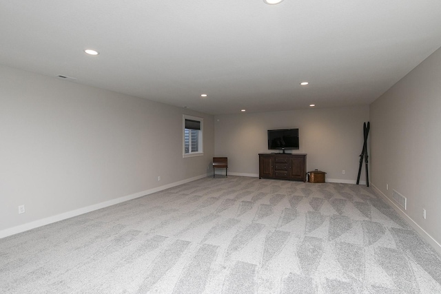 unfurnished living room featuring baseboards, visible vents, and recessed lighting