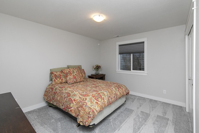 carpeted bedroom with baseboards and visible vents