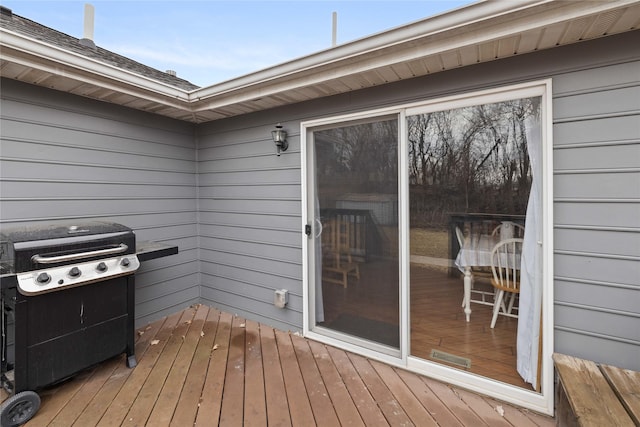 wooden deck with a grill