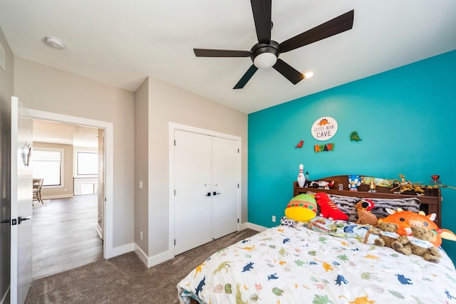 bedroom featuring carpet floors, a closet, baseboards, and a ceiling fan