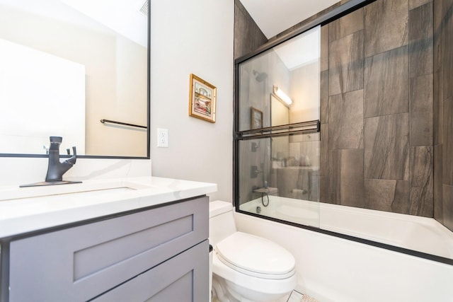 bathroom with toilet, combined bath / shower with glass door, and vanity