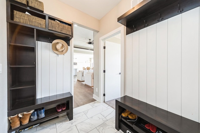 mudroom featuring marble finish floor and ceiling fan