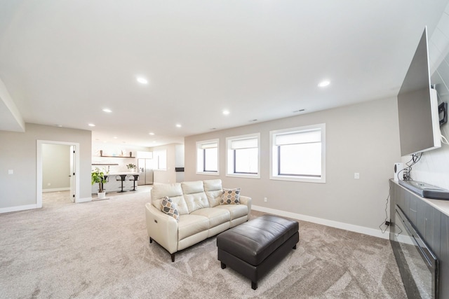 living room featuring light carpet, baseboards, and recessed lighting