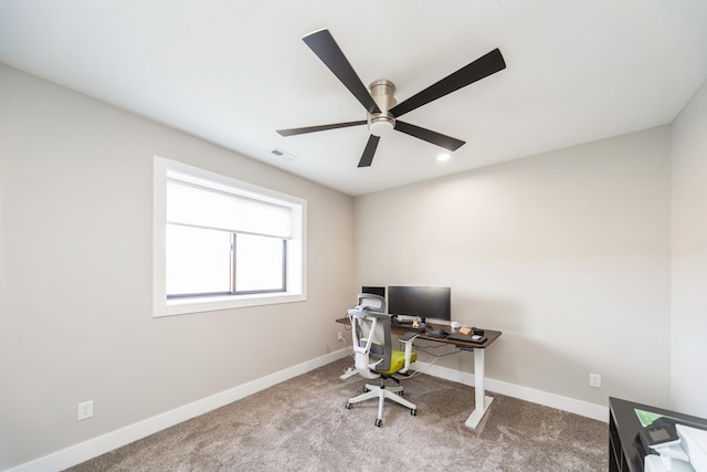 carpeted office featuring a ceiling fan, visible vents, and baseboards