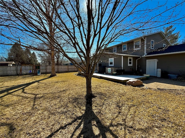 view of yard featuring fence and a patio