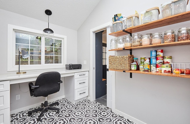 office space with lofted ceiling, tile patterned floors, a textured ceiling, and built in study area