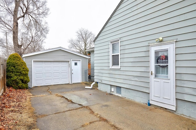 detached garage with driveway and fence