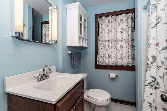 full bathroom featuring toilet, tile patterned flooring, vanity, and baseboards