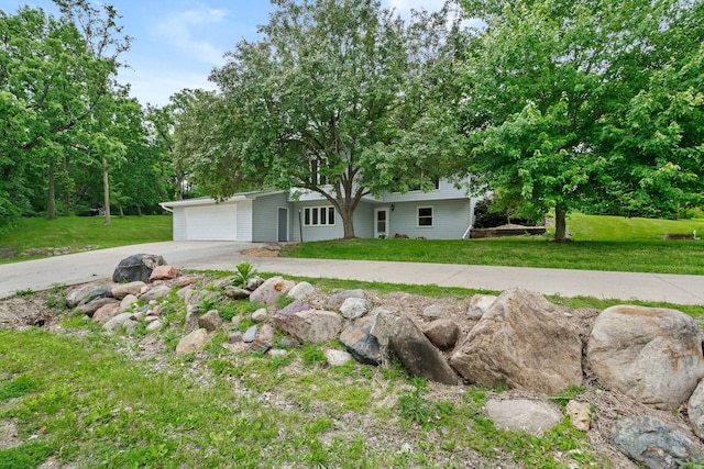 view of front of house featuring a garage, driveway, and a front lawn