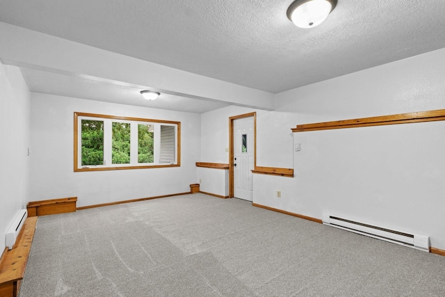 carpeted empty room with a baseboard heating unit, a baseboard radiator, a textured ceiling, and baseboards