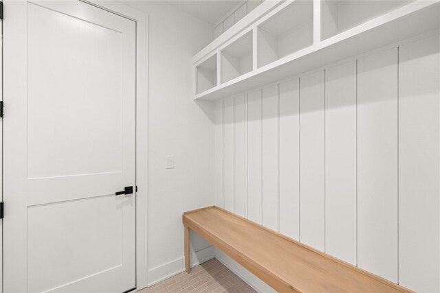 mudroom featuring brick floor